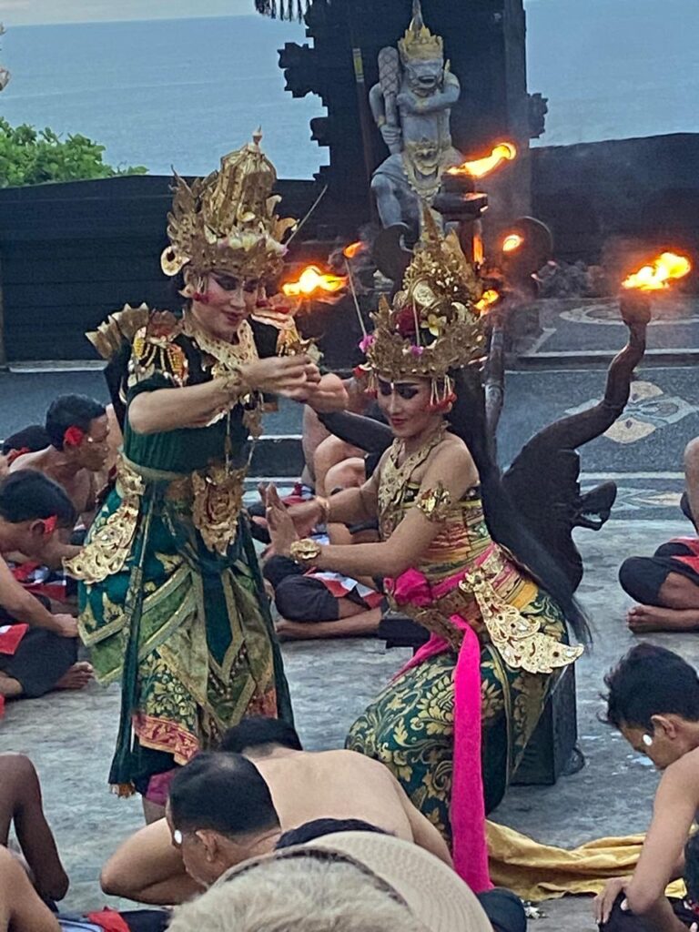 Kecak dancers in traditional Balinese attire performing at Uluwatu Temple Bali