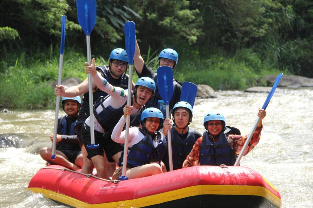 Group rafting on Ayung River in Bali with mother and daughter in front row