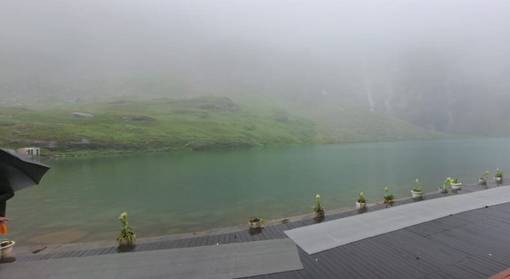 Serene view of the sacred glacial lake at Hemkund Sahib reflecting surrounding peaks