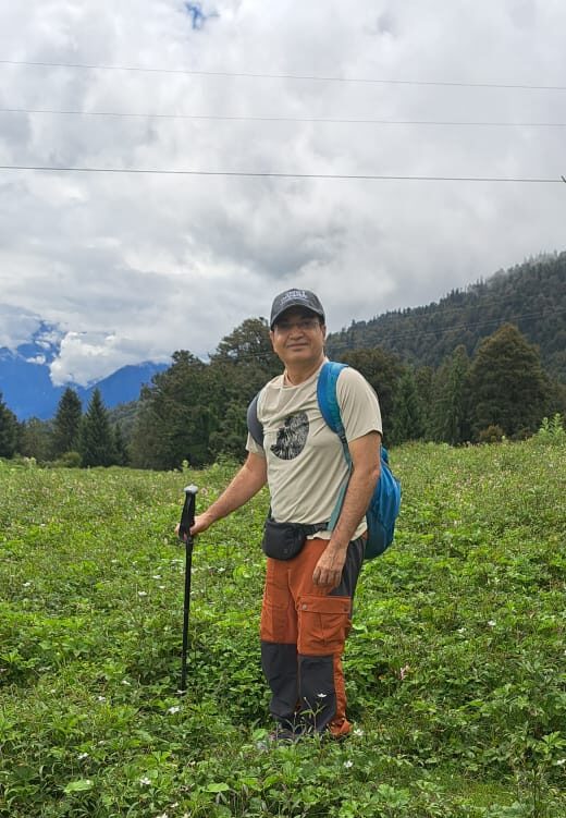 a person standing in Gurson Bugyal surrounded by lush green meadows