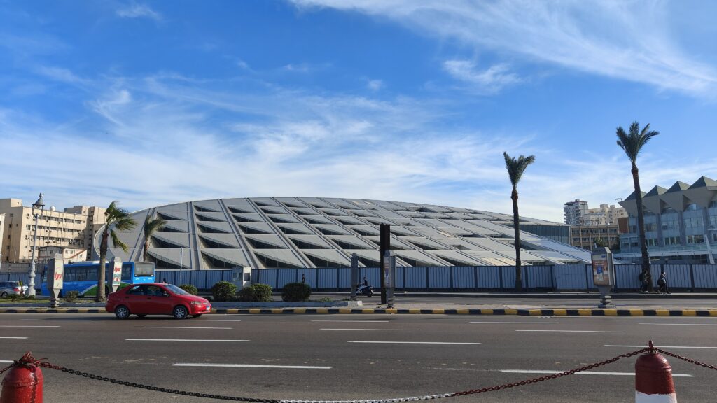 Modern Bibliotheca Alexandrina in Alexandria Egypt under blue sky
