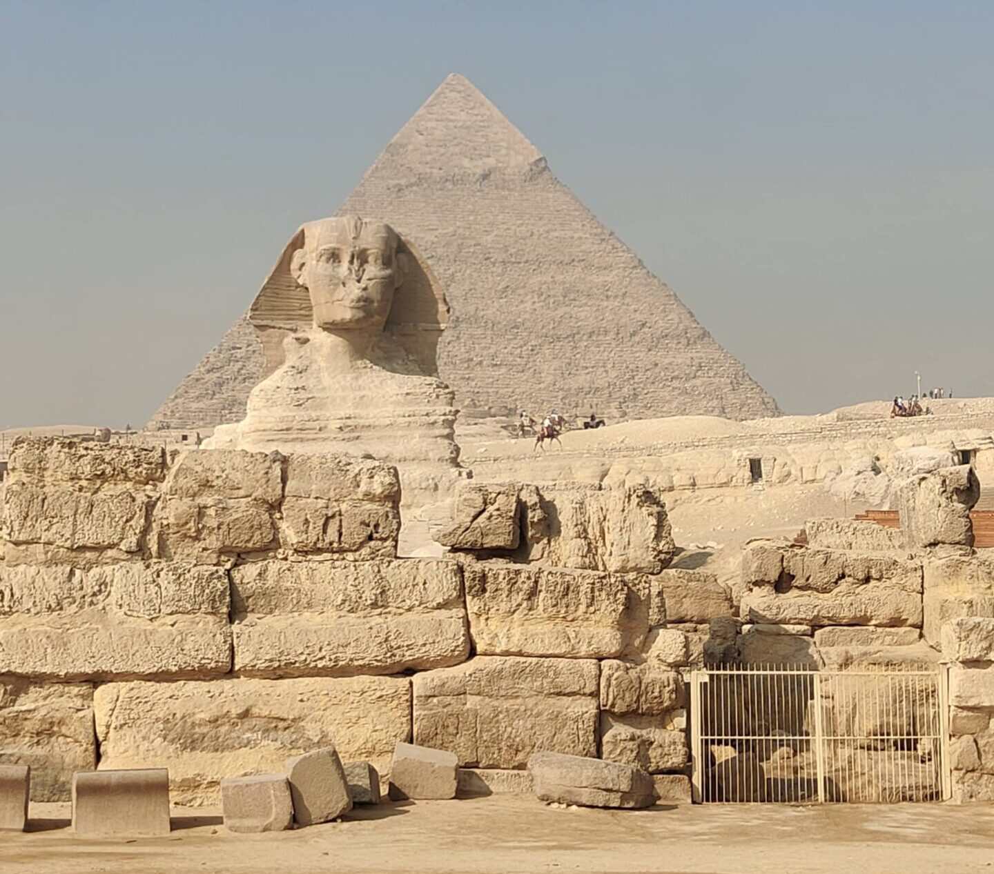 The Great Sphinx standing before the Pyramid of Giza under a clear blue sky in Egypt