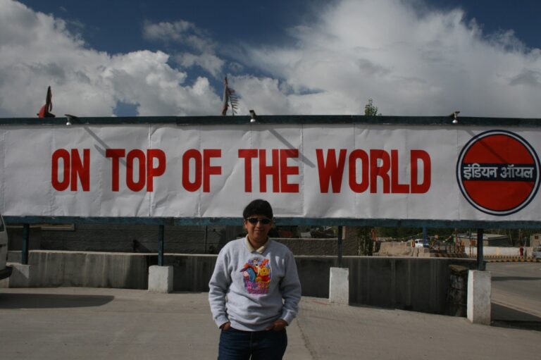 Striking a pose at the iconic “On Top of the World” sign in Ladakh.