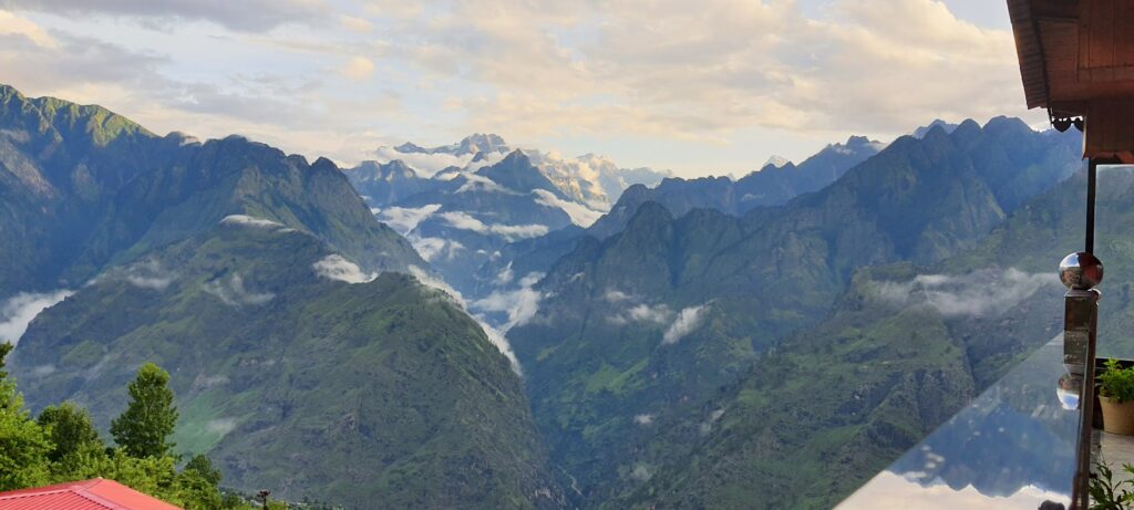 Waking up to the Himalayas—tranquil skies, towering peaks, and clouds drifting through the valley