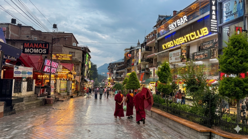 Evening view of Manali market street with monks walking in Himachal Pradesh