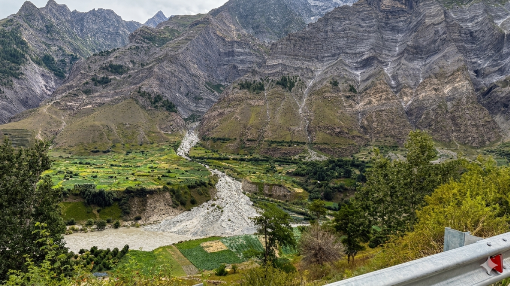 Dramatic mountain landscape in Pangi Valley with river and terraced fields