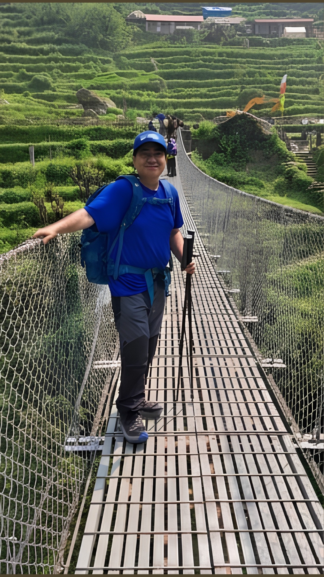 Trekker standing on the suspension bridge over Kimrong Khola during the Annapurna Base Camp Trek in Nepal.